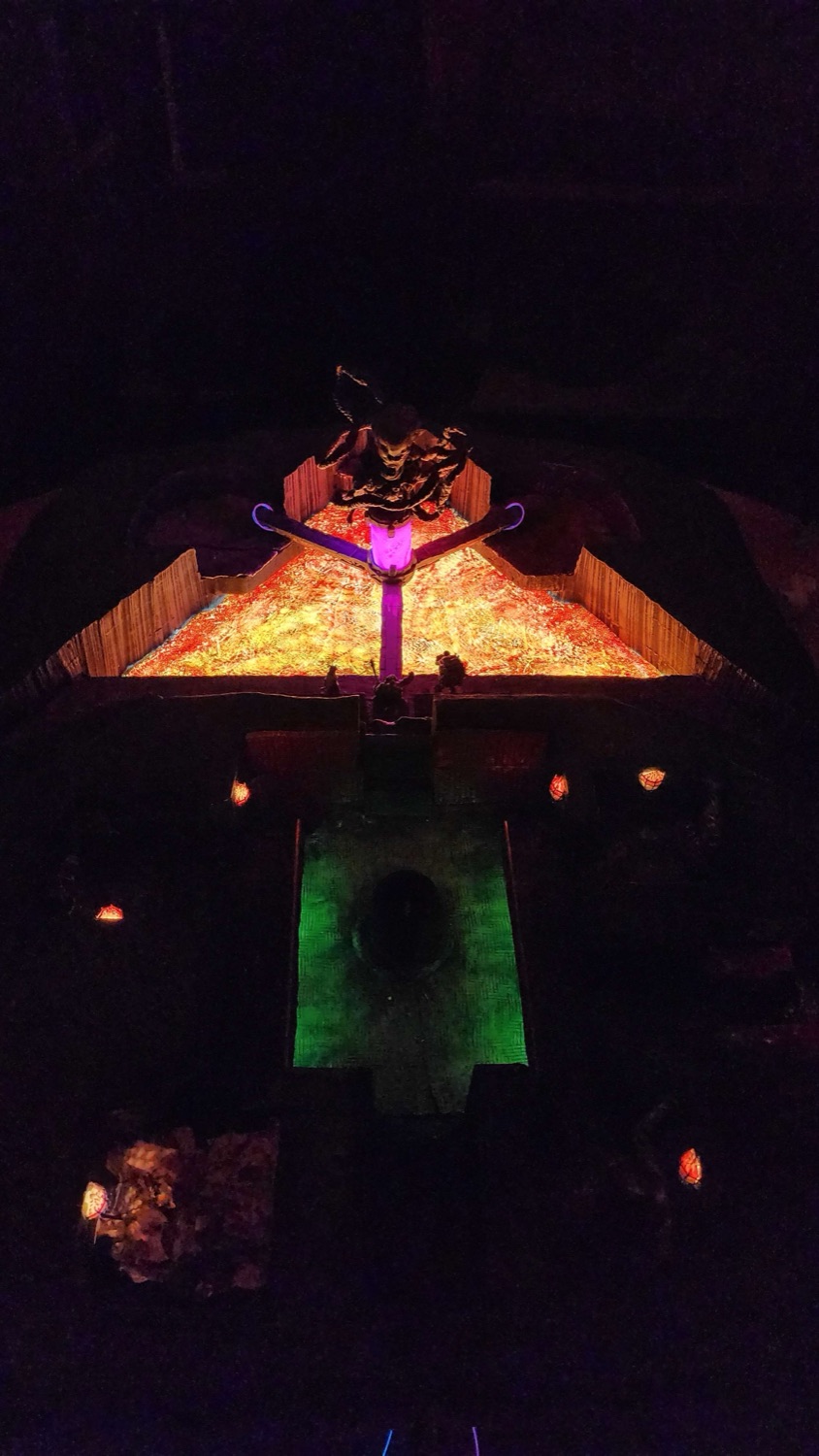The finished battle map lit at night, lava field glowing beneath a green-lit shrine
