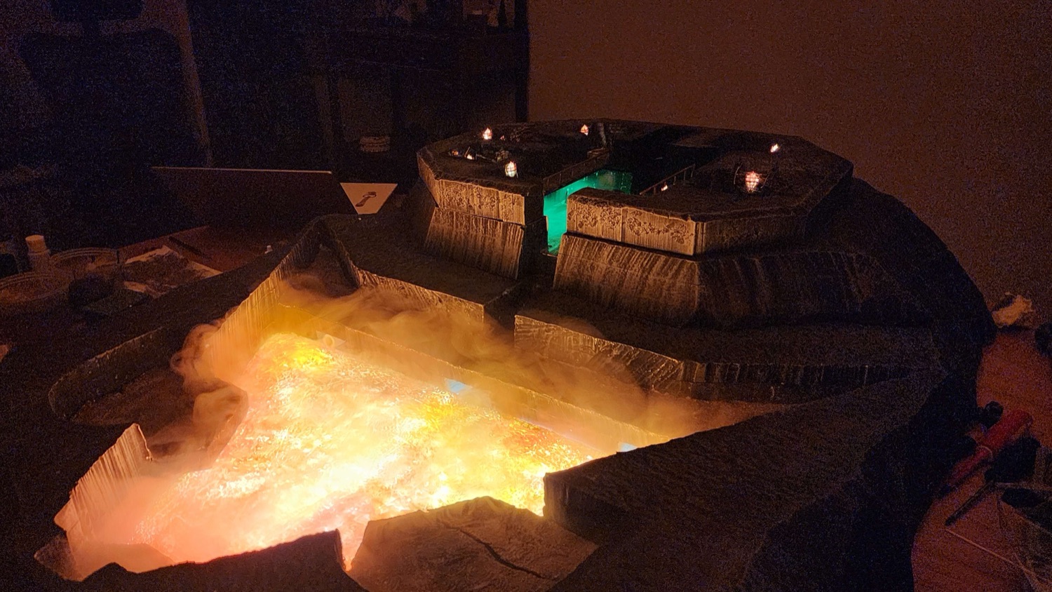 Wide view of the lava basin glowing orange beneath the raised shrine platform.